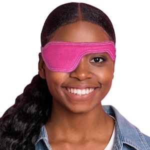 May include: A bright pink fabric eye patch featuring a contoured shape designed to cover one eye. The patch has visible white stitching along the edges and a smooth, solid-colored surface, providing a simple and functional design for eye coverage.