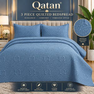 May include: A three-piece blue quilted bedspread set featuring a repeating circular pattern. The set includes a large bedspread and two matching pillow shams. The fabric has a textured, stitched design throughout, providing a uniform appearance.