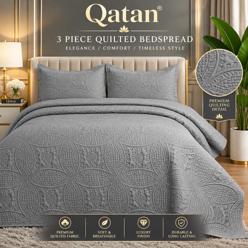 May include: A three-piece grey quilted bedspread set featuring two matching pillow shams and a large coverlet. The fabric displays a repeating circular pattern with intricate textured stitching throughout the surface of the bedding.