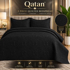 May include: A 3-piece black quilted bedspread set by Qatan featuring a repeating circular pattern. The set includes a large bedspread and two matching pillow shams, all displaying a textured, stitched design on a dark fabric surface.