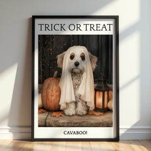 May include: A framed wall art print featuring a dog wearing a white ghost costume. The text TRICK OR TREAT appears at the top and CAVABOO! at the bottom. Beside the dog are a large orange pumpkin and a lit lantern on a stone porch setting.