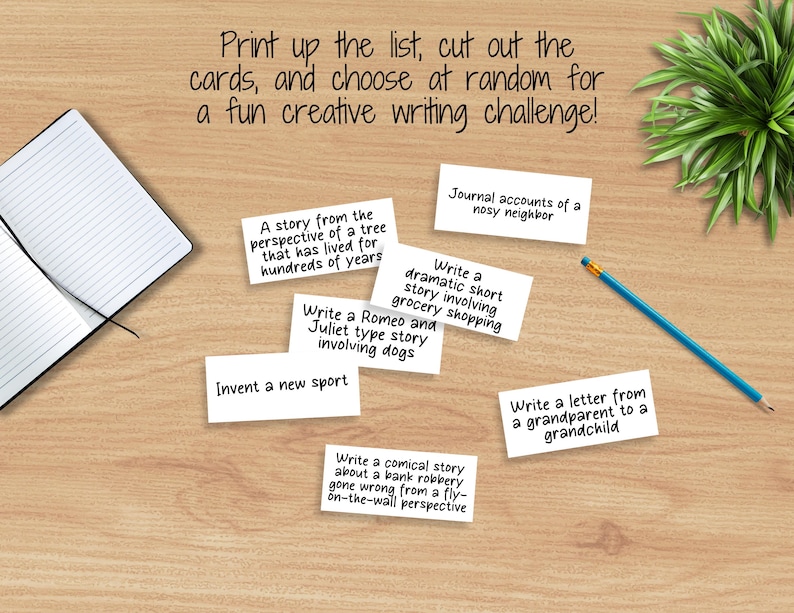 May include: A set of white cards with creative writing prompts, such as "Write a Romeo and Juliet type story involving dogs" and "Journal accounts of a nosy neighbor". The cards are on a wooden surface with a notebook and a pencil.
