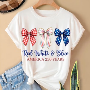 May include: White t-shirt featuring three decorative bows in red gingham, red, white, and blue, and blue with white stars. The text "Red White & Blue AMERICA 250 YEARS" is printed below the bows.