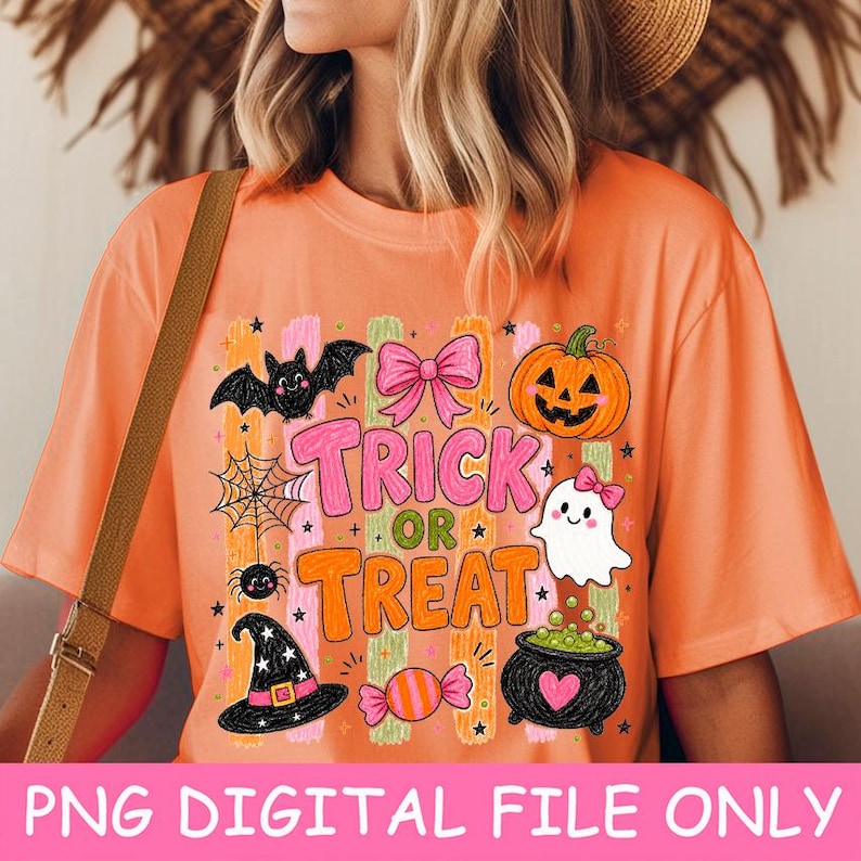 May include: An orange t-shirt featuring a Halloween graphic with the text Trick or Treat. The design includes a black bat, a pink bow, an orange jack-o'-lantern, a spider web, a white ghost, a black witch hat, a candy, and a black cauldron.