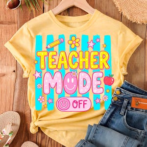 May include: Yellow t-shirt with the text "TEACHER MODE OFF" in a colorful design. The shirt features a pencil, flowers, stars, and an apple graphic. Blue jeans and accessories are visible.