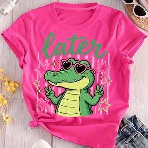 Cute Later Gator PNG for sublimation featuring cartoon crocodile in heart glasses on shirt