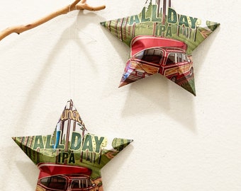 May include: Two green, red, and brown paper star ornaments with the text "Ouncil All Day IPA" and a vintage station wagon graphic.