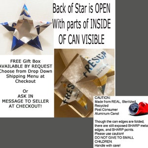 May include: Handmade star decorations made from recycled aluminium cans. The stars are blue and silver, with visible text from the original cans. The back of the star is open, showing the inside. The image also shows the stars in a gift box.