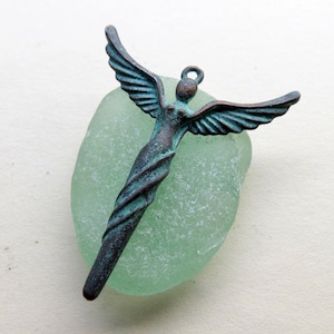 MYKONOS WINGED GODDESS .  41 mm by 50 mm . 1 charm . Greek Charms, Pendants and Buttons