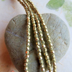 New FACETED GOLDEN ROUNDS . 50  Czech Fire Polished Glass Beads . 2  mm . Supplies for Jewelry Making