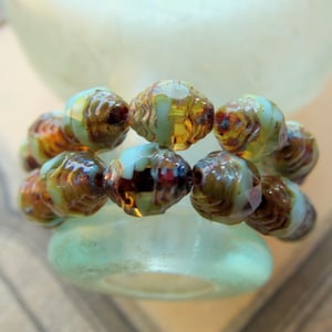 Koraliki ze szkła czeskiego Picasso z niebieskim topazem: owalne, 8 x 6 mm, materiały jubilerskie