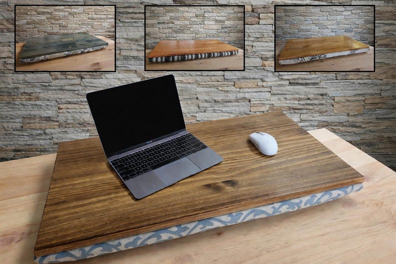 May include: A wooden laptop desk with a dark brown finish and a patterned fabric base. A laptop and a white mouse are on the desk. Three smaller images of similar desks are in the background.