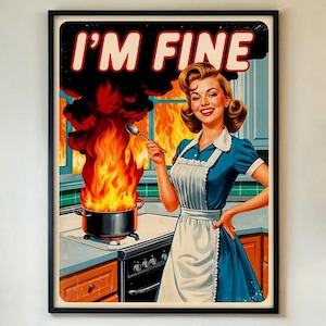 May include: A framed retro print showing a woman in a blue dress and apron smiling in a kitchen with a pot on fire. The text "I'M FINE" is displayed above the woman's head in white letters on a black background.