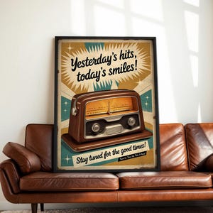 May include: A framed vintage-style poster featuring a brown radio with a cream-colored face. The poster has the text "Yesterday's hits, today's smiles!" and "Stay tuned for the good times!" against a tan and teal background.