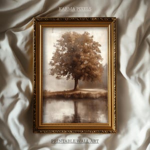 May include: Framed wall art featuring a sepia-toned landscape with a large tree reflected in a body of water. The artwork is in a gold ornate frame. The text "KARMA PIXELS" and "PRINTABLE WALL ART" are visible.