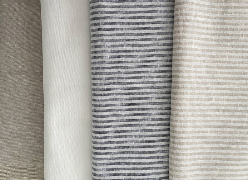 May include: Three fabric swatches, one solid beige, one solid white, and one striped with black and white stripes.