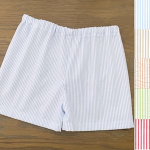 May include: Light blue striped shorts with a white elastic waistband.