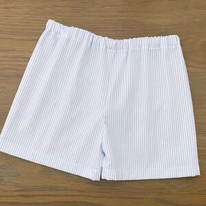 May include: White and blue striped shorts with a wide elastic waistband.