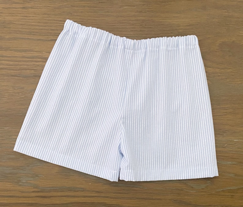 May include: White and blue striped shorts with a wide elastic waistband.