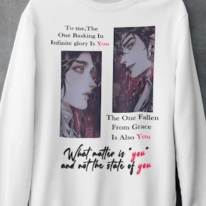 May include: White sweatshirt with a graphic featuring two illustrated portraits and text. The text includes phrases like "Infinite glory is You" and "What matter is you". The sweatshirt is hanging on a metal hanger.