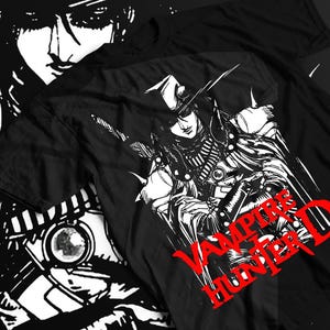 May include: Black t-shirt featuring a detailed white and red graphic of a character with a hat and weapons, with the text "VAMPIRE HUNTER D" in red. The design is a stylized illustration.