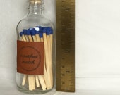 NEW SIZE, LARGER bottle, longer matches, leather label