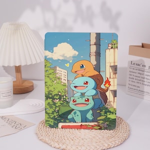 May include: A tablet case with a vibrant illustration of three cartoon characters. The top character is orange, the middle is blue, and the bottom is green. The background depicts a city scene with trees and a blue sky.