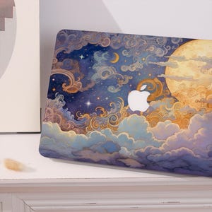 May include: A laptop skin featuring a celestial night sky illustration with a large yellow moon, swirling clouds in shades of blue, purple, and gold, and scattered stars. The white Apple logo is visible in the center of the design.