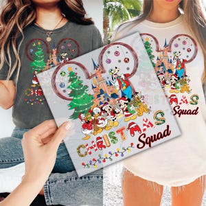 a couple of women holding up a picture of mickey mouse