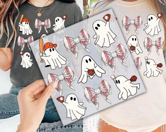 May include: Two t-shirts, one gray and one cream, feature a baseball-themed design. The design includes cartoon ghosts with baseball bats, gloves, and baseballs, along with baseball bow accents. The design is printed on the front of the shirts.