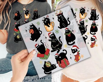 May include: Two white t-shirts featuring black cat illustrations. The cats are wearing Santa hats, holding baubles, and some are adorned with Christmas lights. These shirts are a fun way to express your love for cats and the festive season.