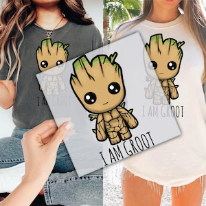 May include: Two white t-shirts with a cartoon image of a green and brown Groot character from the Guardians of the Galaxy movie. The text "I am Groot" is printed on the shirts.