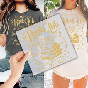 May include: A gold vinyl decal with the text "House of Wind Book Club" and a stack of books with a flower design. The text "Est. Valkyrie Reading Room" is also included.
