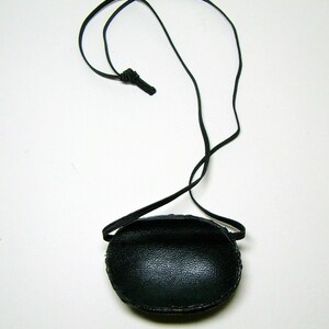 May include: A black leather eye patch with an adjustable elastic strap.