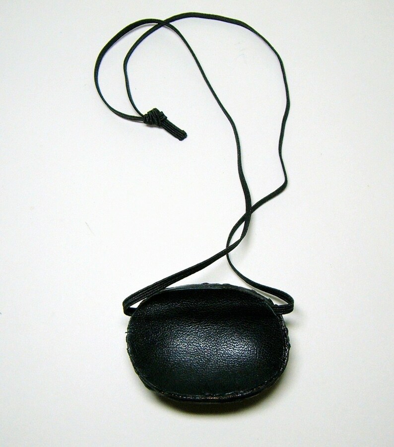 May include: A black leather eye patch with an adjustable elastic strap.