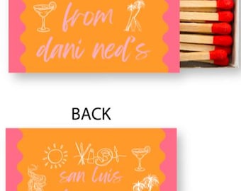 May include: Orange matchbox with pink edges. The front of the box says "i stole this from dani ned's". The back of the box has a sun, a mermaid, a cow, a wave, a cocktail glass, and the text "san luis obispo, ca".
