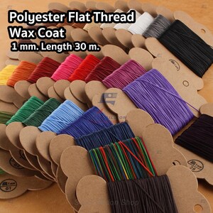 May include: A selection of brightly coloured polyester flat thread spools with a wax coating. The spools are displayed on brown cardboard cards. The image text reads "Polyester Flat Thread Wax Coat 1 mm. Length 30 m."