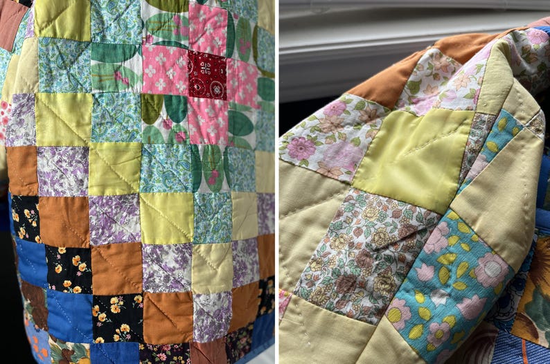 A colourful quilted jacket is displayed on a teal mannequin.  It features a patchwork design with various floral & patterned squares in shades of blue, pink, yellow, orange, and green.  Blue trim outlines the pockets and edges.