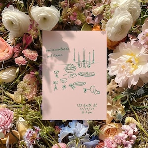 May include: A pink invitation card with green illustrations of a dinner table setting with candles, plates, glasses, and food. The text on the card reads "you're invited to girl dinner" and "123 Smith St 12/04/24 @ 6 pm".