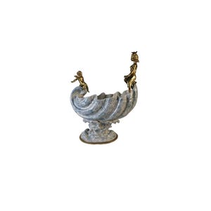 Antique porcelain bowl in the shape of a shell with bronze angels. Luxurious decorative and functional bowl. Perfect for a gift