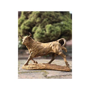 Antique cast iron sculpture of the Bull. Rustic figurine garden and home decoration. Beautiful and stylish cast iron sculpture