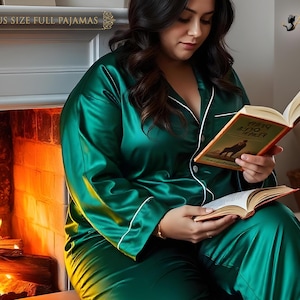 May include: A woman wearing a green satin pajama set with white piping. She is sitting in front of a fireplace and reading a book titled "Mary Jo Duffy".
