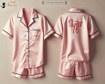 May include: Pink satin pajamas with black trim. The top has a button-up front and a pocket with the name "Angela" embroidered on it. The back of the top has the text "Sweet 16" in red glitter.