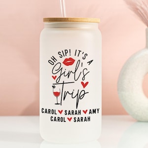 May include: Frosted glass tumbler with a bamboo lid and straw. The tumbler features the text "Oh Sip! It's a Girl's Trip" with a lipstick kiss, hearts, and a cocktail illustration. Names are listed below the text.