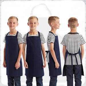May include: Four images of a person wearing a navy blue apron over a striped shirt and jeans. The apron has a neck strap and waist ties. The shirt is white with horizontal black stripes. The person is standing in front of a white background.
