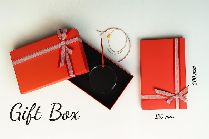 May include: Red gift boxes with silver ribbon and bows. One box is open, revealing a black interior and a clear circular ornament. The text "Gift Box" is at the bottom. The closed box is 120 mm x 200 mm.
