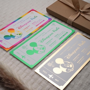 May include: Three colorful ticket-shaped invitations with a Mickey Mouse character and the text "Pack your bags, you are going to Disneyland Paris".