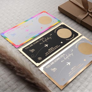 May include: Three gold foil scratch-off cards with a rainbow, black, and gray background. Each card has a gold circle to scratch off to reveal a hidden message. The text on the cards reads "You are going on a holiday".