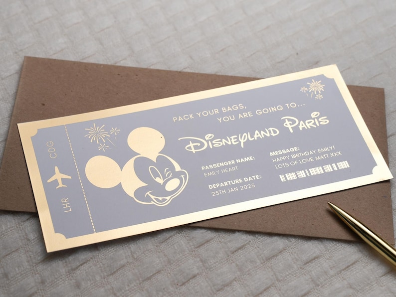May include: A gold-colored ticket with a purple background, featuring a cartoon image of Mickey Mouse. The ticket reads "Pack your bags, you are going to... Disneyland Paris". The ticket also includes a passenger name, departure date, and a message.
