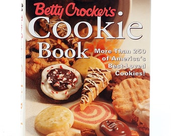 May include: A vintage Betty Crocker's Cookie Book with a colorful cover featuring a variety of cookies. The back cover lists the book's contents, including "The Most Delicious, Delectable, and Bakable Collection of Cookies Ever!" and "The Only Cookie Book You'll Ever Need."